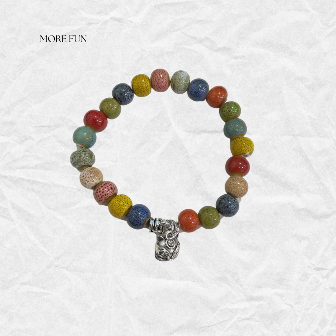 Praying bracelet crafted with textured ceramic beads and a unique silver charm, offering a fun and stylish accessory.